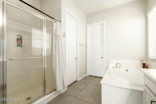 bathroom with tile patterned flooring, shower with separate bathtub, and vanity