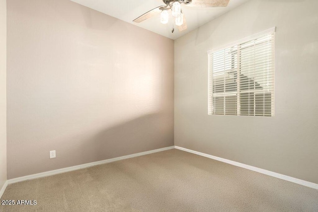 carpeted spare room with ceiling fan