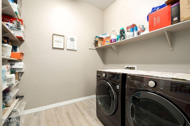 washroom with independent washer and dryer and light wood-type flooring