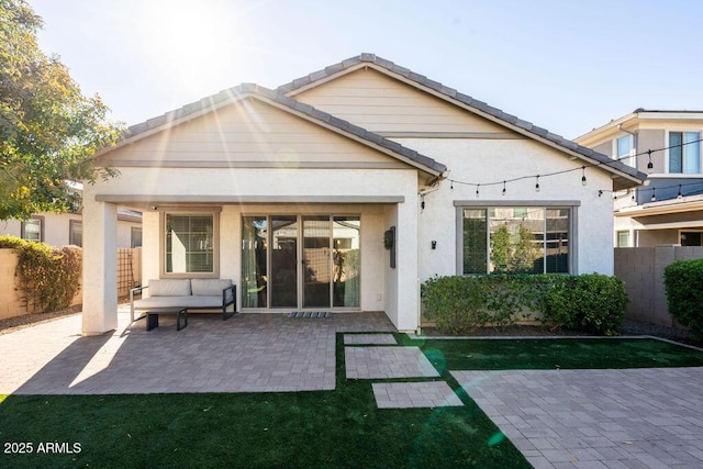 back of house with an outdoor hangout area and a patio