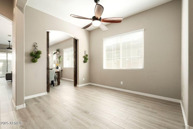 spare room featuring ceiling fan and light hardwood / wood-style floors