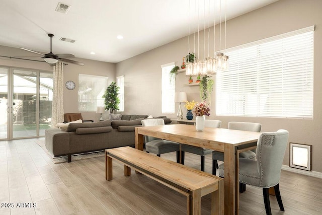 dining room featuring ceiling fan, light wood-type flooring, and plenty of natural light