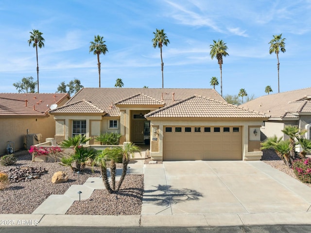 view of front of property with a garage, concrete driveway, a tiled roof, and stucco siding