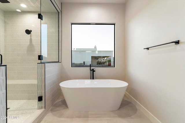 bathroom featuring tile patterned flooring and plus walk in shower