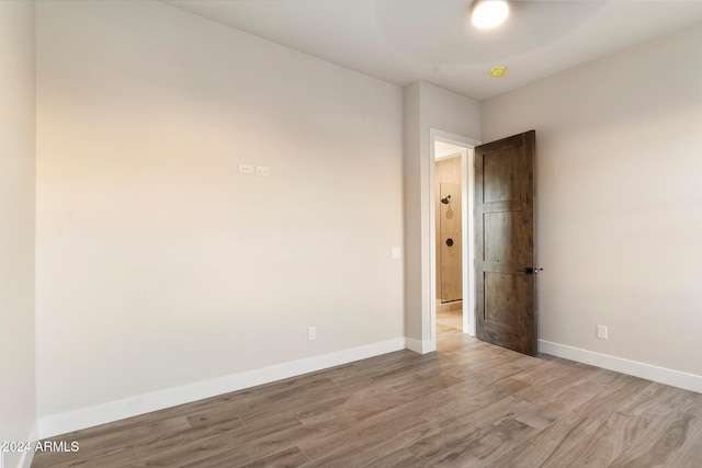 spare room with light wood-type flooring