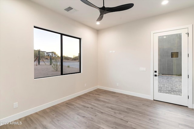 spare room with light hardwood / wood-style floors and ceiling fan