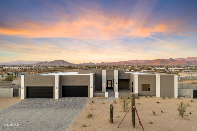 adobe home featuring a mountain view and a garage