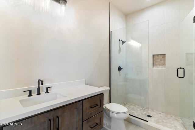 bathroom with vanity, toilet, and walk in shower