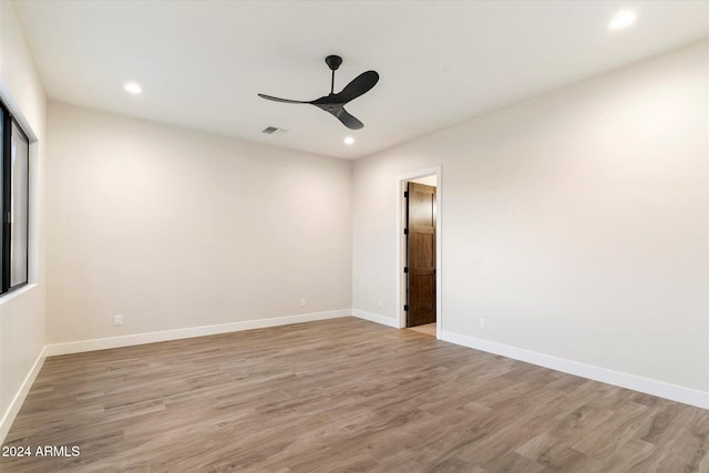 empty room featuring ceiling fan and light hardwood / wood-style flooring