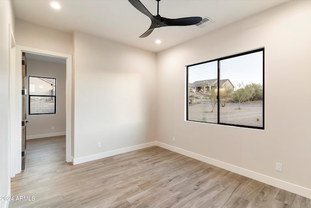 empty room featuring ceiling fan and light wood-type flooring