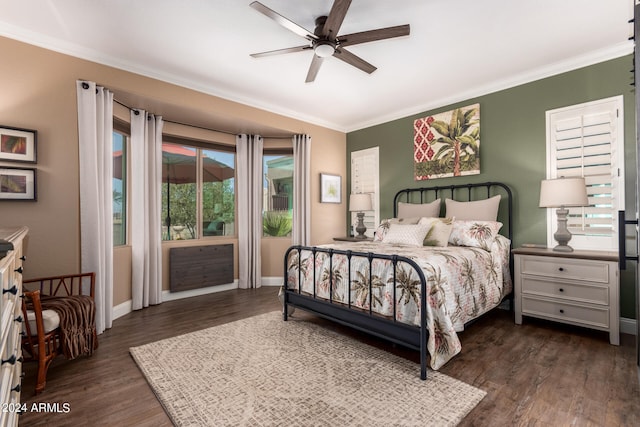 bedroom with dark wood-type flooring, ceiling fan, and crown molding