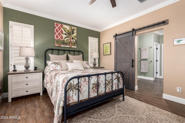 bedroom with ornamental molding, a barn door, ceiling fan, and dark hardwood / wood-style flooring