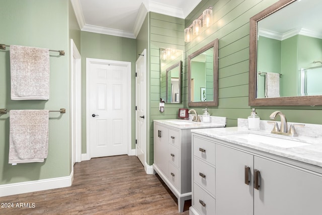 bathroom with hardwood / wood-style flooring, ornamental molding, and vanity