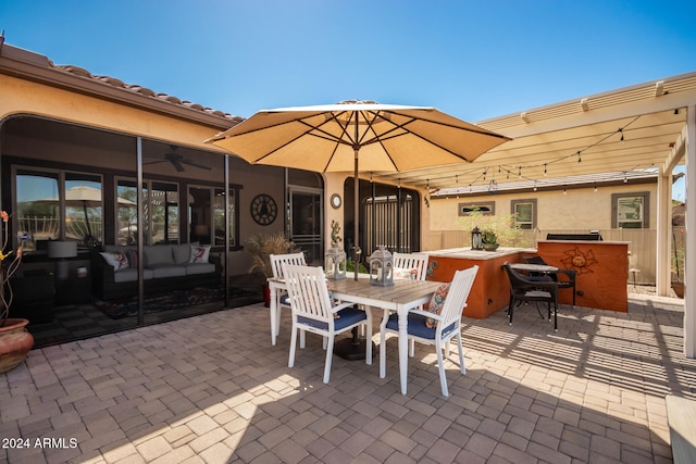 view of patio / terrace with a bar, ceiling fan, and an outdoor hangout area