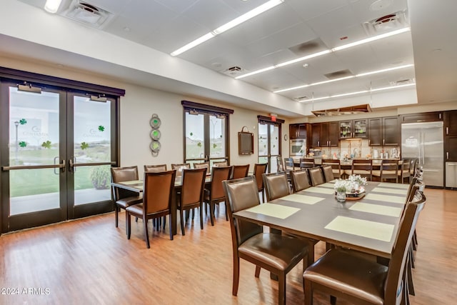 dining room featuring light hardwood / wood-style floors and french doors