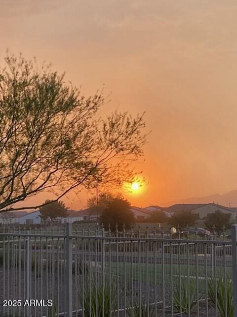 gate at dusk with a mountain view