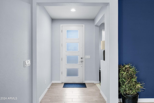 doorway with light wood-type flooring