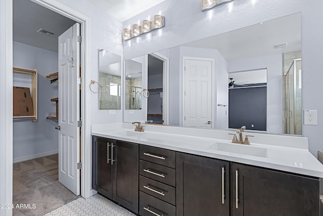 bathroom featuring vanity, ceiling fan, and a shower with shower door