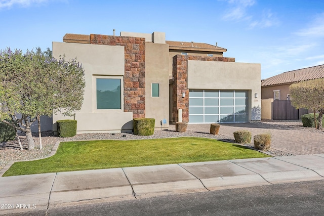 view of front of house featuring a front yard and a garage