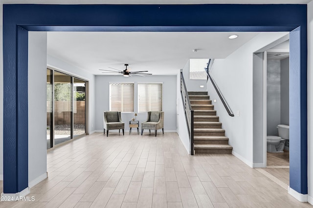 interior space with ceiling fan