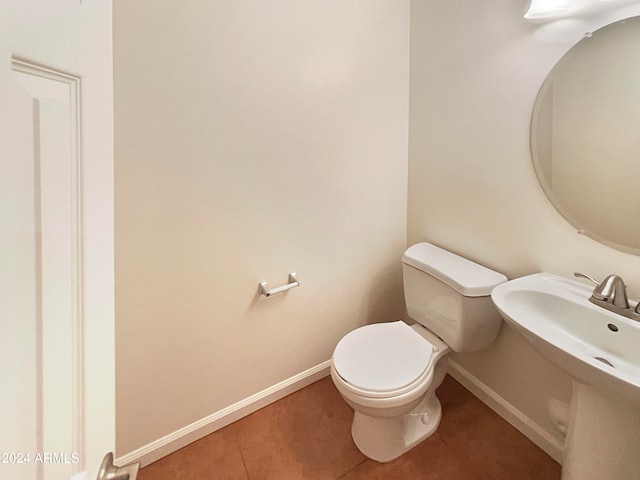 bathroom featuring tile flooring and toilet