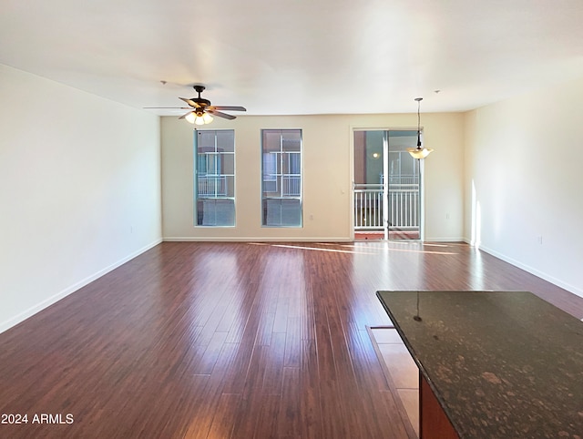 spare room featuring dark hardwood / wood-style floors and ceiling fan
