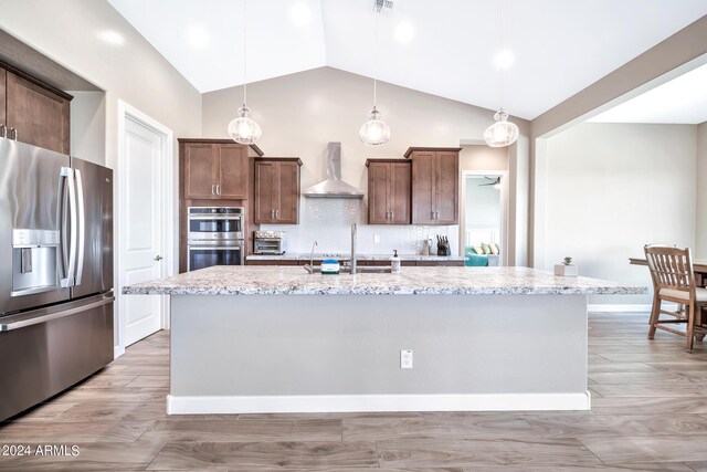 kitchen featuring lofted ceiling, sink, and hanging light fixtures