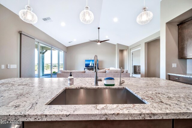 kitchen with appliances with stainless steel finishes, light hardwood / wood-style floors, hanging light fixtures, and sink