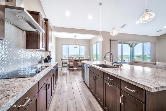 dining room with a wealth of natural light, hardwood / wood-style floors, and ceiling fan with notable chandelier