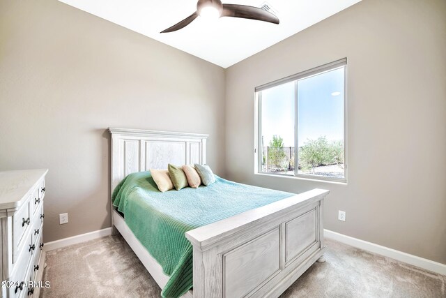 bedroom featuring ceiling fan, light carpet, and a closet