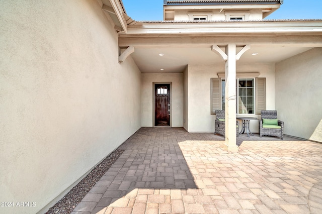 entrance to property featuring a patio area