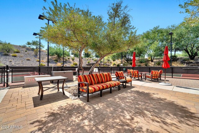 surrounding community featuring outdoor lounge area and a patio area