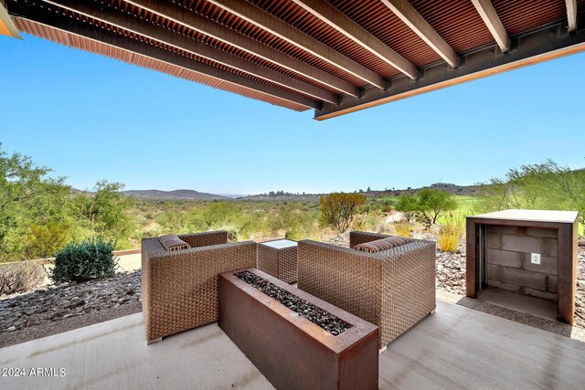 view of patio / terrace featuring a mountain view and an outdoor fire pit