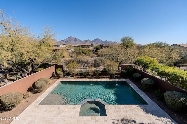 view of pool with a mountain view and an in ground hot tub