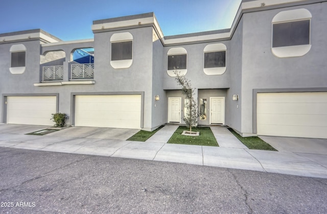 1851 W Vermont Ave, Phoenix, AZ 85015 - townhome / multi-family property with stucco siding, a garage, a balcony, and driveway