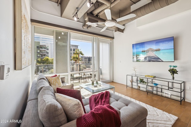 living room featuring a ceiling fan and wood finished floors