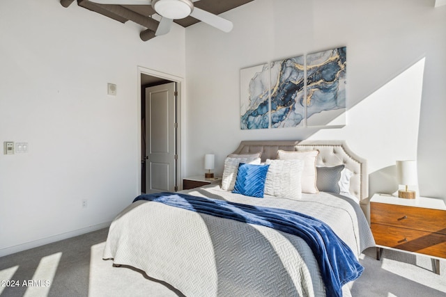 carpeted bedroom featuring vaulted ceiling with beams and a ceiling fan