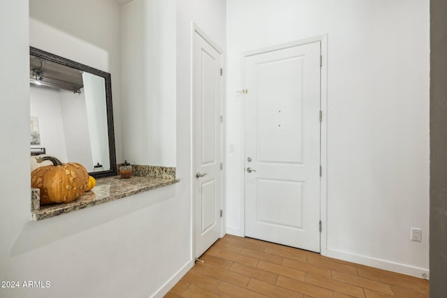 entryway with light wood-style floors and baseboards