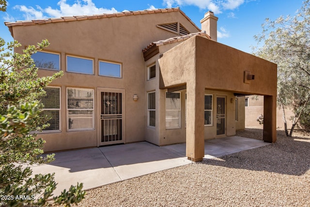 13680 E Paradise Dr, Scottsdale, AZ 85259 - rear view of property with a patio, stucco siding, a chimney, and a tile roof