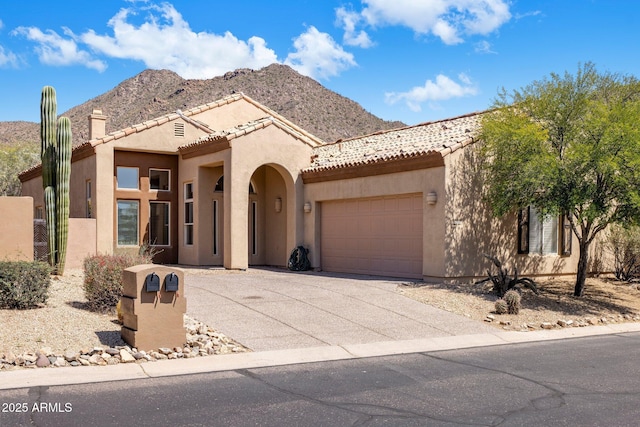 13680 E Paradise Dr, Scottsdale, AZ 85259 - view of front of house featuring an attached garage, a mountain view, stucco siding, and concrete driveway