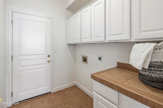 13680 E Paradise Dr, Scottsdale, AZ 85259 - washroom with light tile patterned floors, baseboards, washer hookup, hookup for an electric dryer, and cabinet space