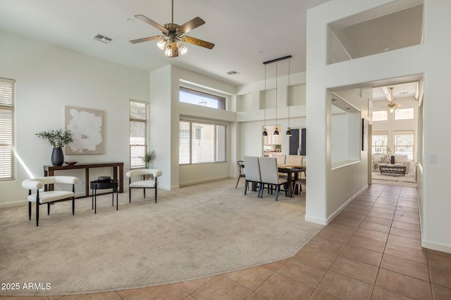 13680 E Paradise Dr, Scottsdale, AZ 85259 - carpeted living area with a high ceiling, ceiling fan, visible vents, and a wealth of natural light