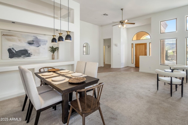 13680 E Paradise Dr, Scottsdale, AZ 85259 - dining space with baseboards, light carpet, a high ceiling, a ceiling fan, and visible vents