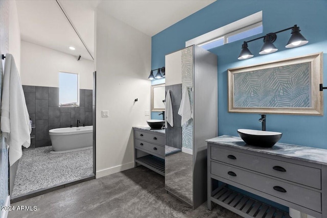 bathroom featuring tile walls, concrete flooring, independent shower and bath, and vanity