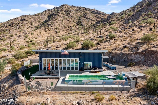 rear view of property with a mountain view and a patio