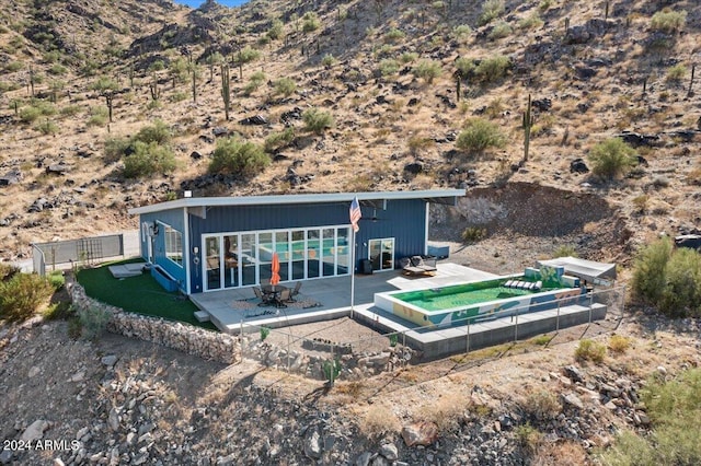 back of house featuring a patio, fence, and a mountain view