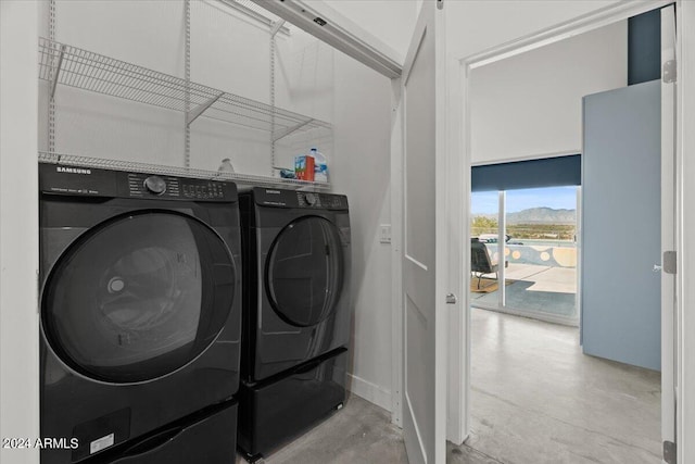 clothes washing area with washer and clothes dryer and laundry area