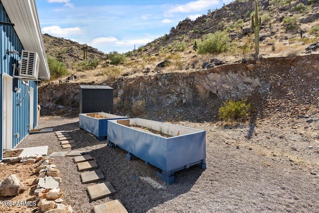 view of yard featuring a mountain view and a garden