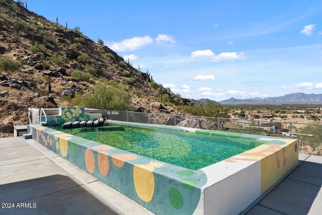 view of pool with a mountain view