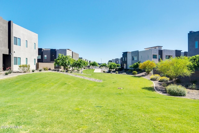 view of property's community with a lawn